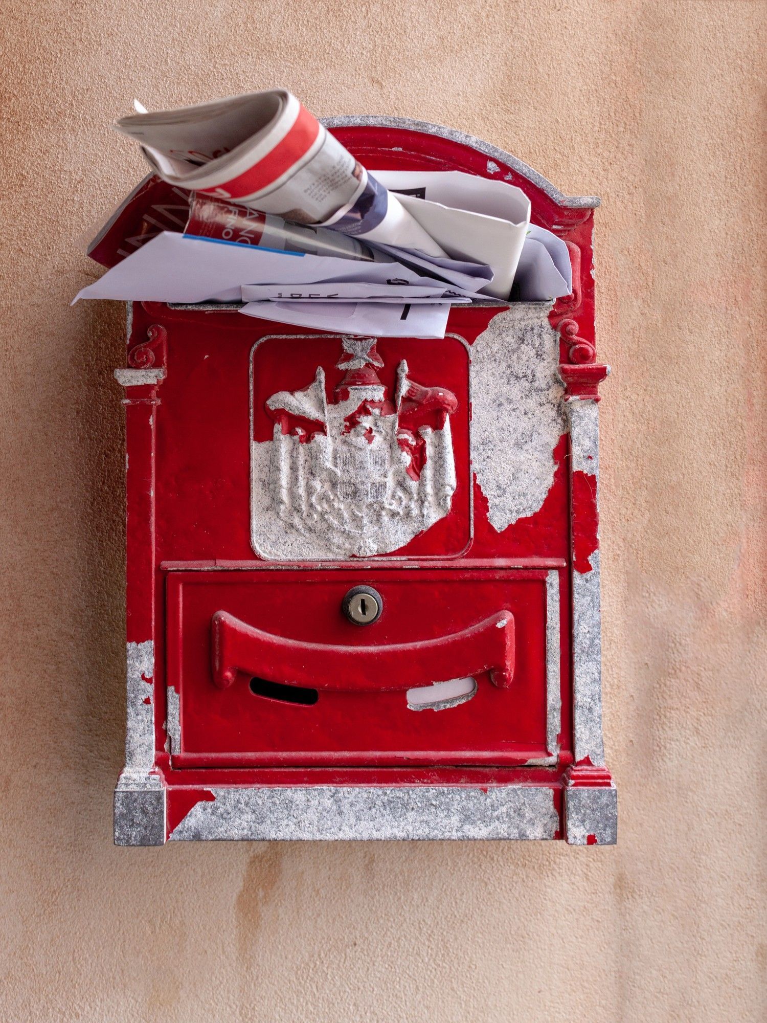 Overfilled red mailbox symbolizing the importance of balancing email frequency and timing to prevent subscriber fatigue.