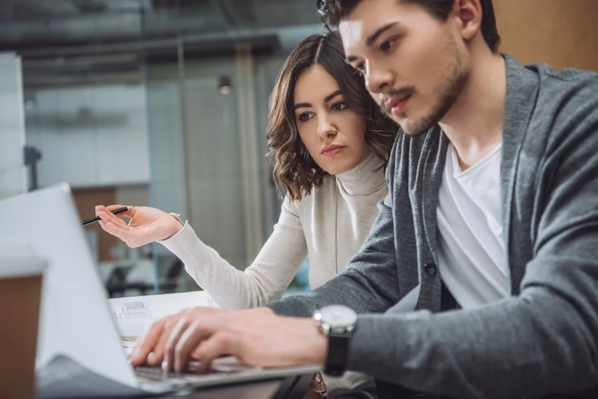 Two startup founders discussing strategies for effective bulk email marketing content, symbolizing collaboration and creativity.