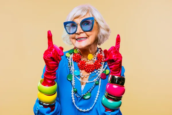Colorful older woman with bold style, representing a brand voice that's personal, authentic, and full of personality.