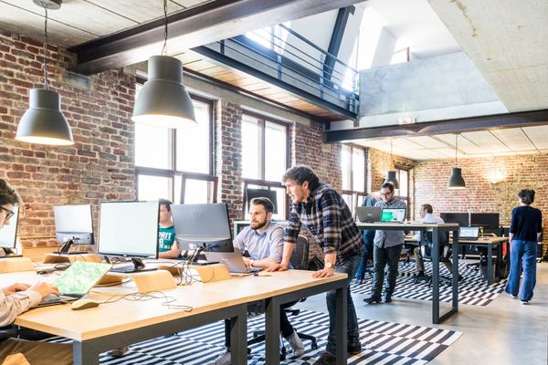 A team of young professionals working in a startup office.