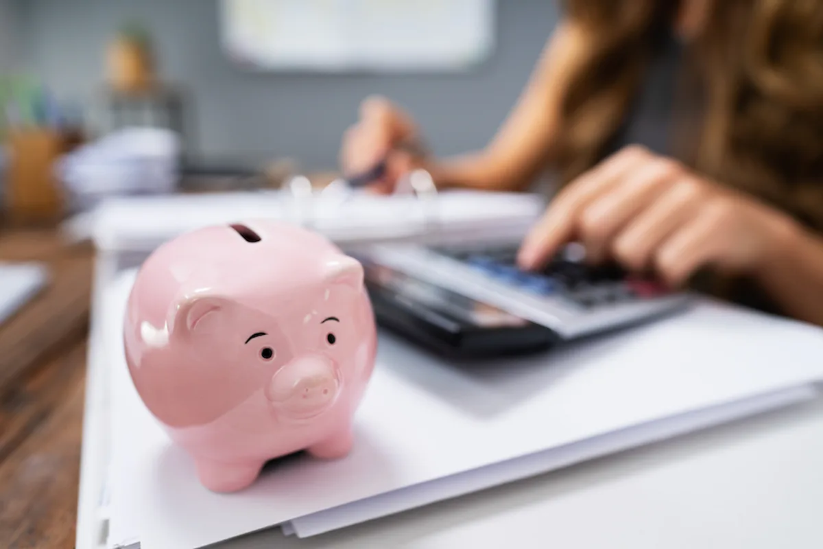 Entrepreneur calculating budget for hiring freelancers, emphasizing smart financial planning and negotiation.