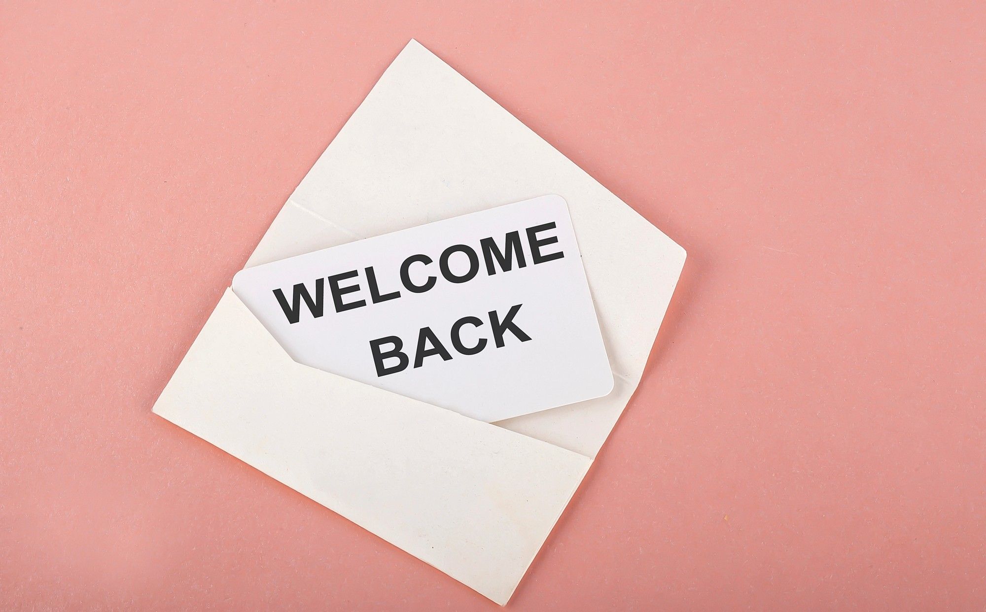 Envelope with a "Welcome Back" card inside, symbolizing warm email outreach to re-engage inactive subscribers.