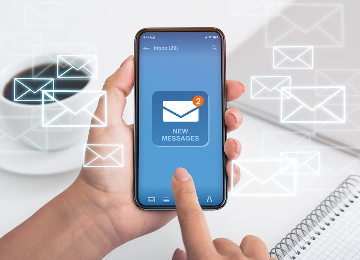 Person receiving a new email on a smartphone, showcasing mobile accessibility in email marketing