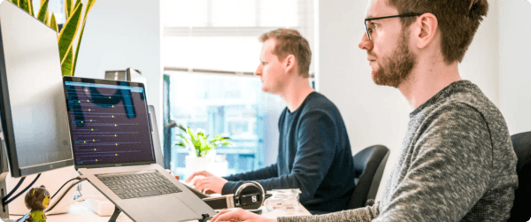 Two men working on a startup in a modern office.