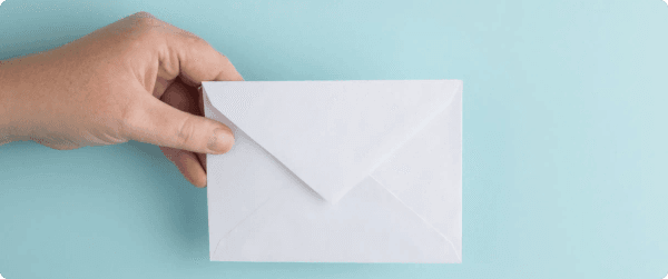 A hand holding a mail envelope resembling an email icon.