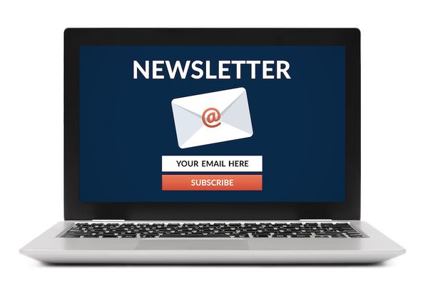 A laptop displaying an email newsletter signup page with the option to subscribe.