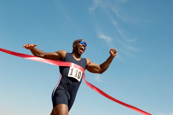 A runner triumphantly crossing the finish line, symbolizing successful email marketing best practices that drive campaigns to victory.