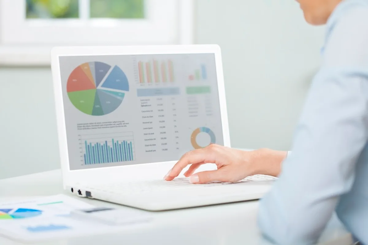 Person analyzing email campaign performance data on a laptop, focusing on key metrics.