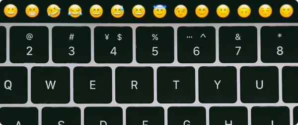 A keyboard with emojis above it, highlighting their use in subject lines.