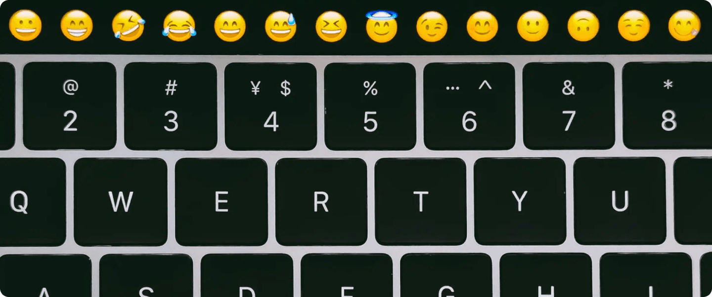 A keyboard with emojis above it, highlighting their use in subject lines.