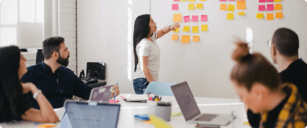 A woman presenting strategies to her team on how to manage email lists.