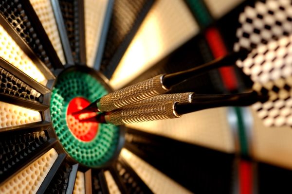 Dartboard with darts hitting the bullseye, symbolizing precise targeting and the effectiveness of targeted email marketing.